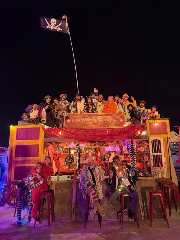 The Frick Frack crew on the roof and at the bar of the blackjack wagon under a pirate flag