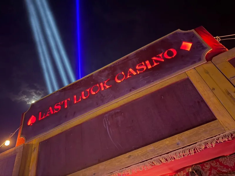 The wagon's illuminated sign against searchlights and the moon